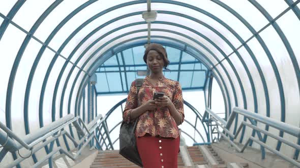 Cute African American Girl Texting on Phone Attended on Screen of Tablet, Afro Female, Beautiful