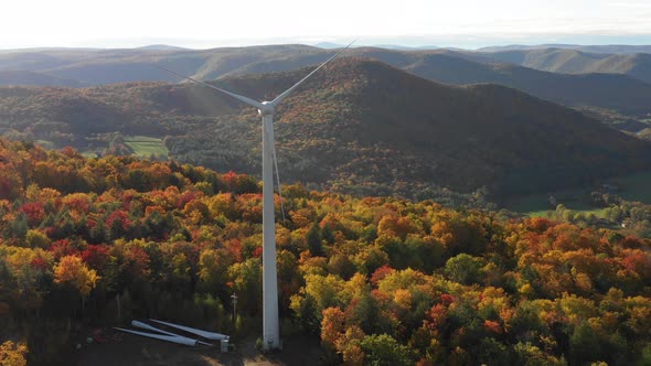 Electric Windmill turbine wind farm aerial clean energy colorful hills in autumn