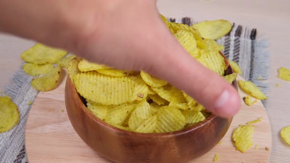 Potato Fluted Chips Are Eaten with Your Hands From a Bowl