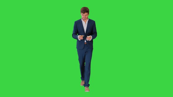 Happy Businessman Counting Money and Tucking It Inside His Jacket While Walking on a Green Screen