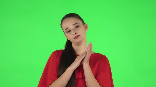 Portrait of Pretty Young Woman Is Clapping Her Hands with Dissatisfaction. Green Screen