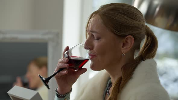 Closeup of Desperate Depressed Middle Aged Rich Lady Drinking Wine Crying Looking at Photo