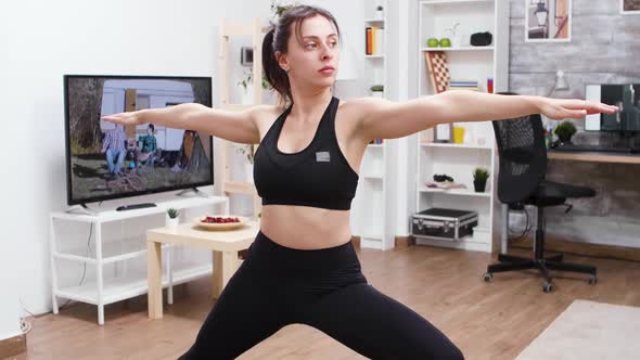 Young Female Doing Yoga Exercise in Living Room