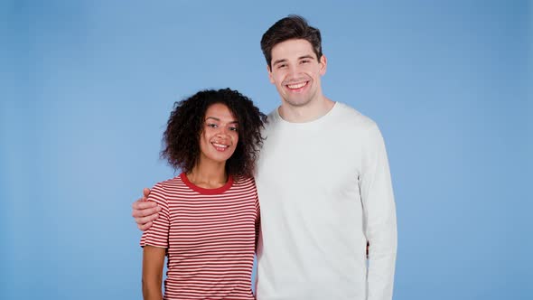 Portrait of Young Couple on Blue Studio Background