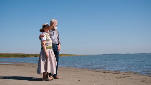 Happy Mature Senior Couple Stand Embracing at the Seaside Beautiful Romantic Elderly Middleaged