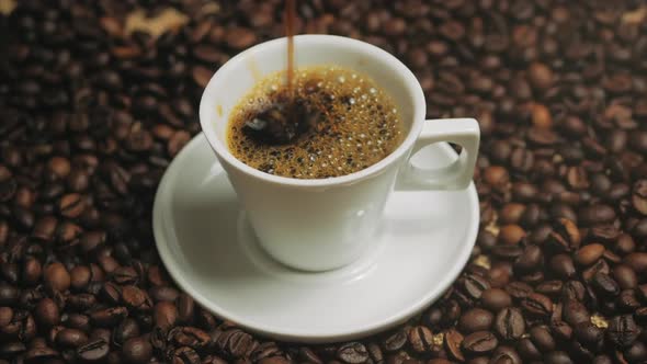 Coffee Cup and Coffee Beans. White Cup of Evaporating Coffee on the Table with Roasted Bean. Stock