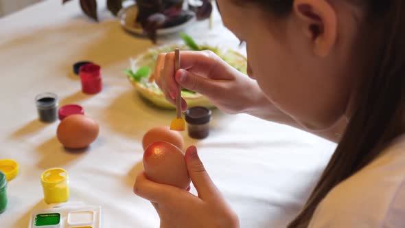 Happy Pretty Child Girl Having Fun During Painting Eggs for Easter at Home