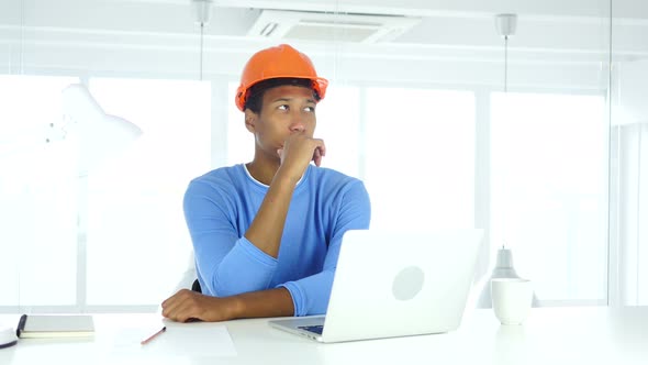 Afro-American Engineer Thinking and Working on Laptop