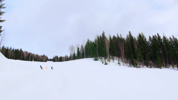 People snowboarding on snowy mountain