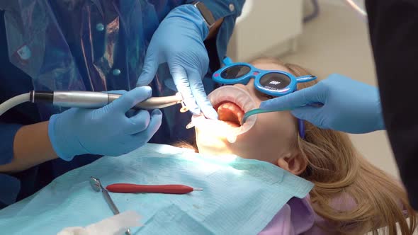 Kid Girl with Oral Dilator at Dentist's Appointment
