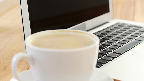 Cup of coffee and laptop