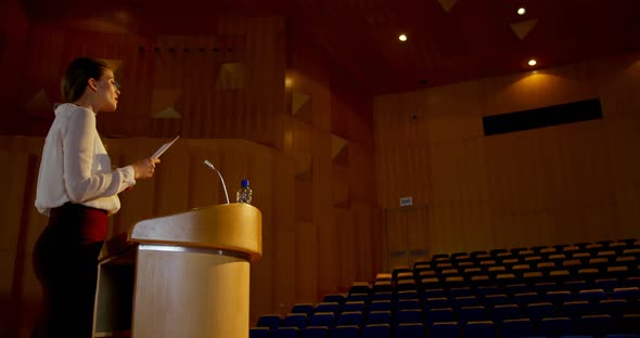 Young Caucasian businesswoman practicing speech in empty auditorium 4k