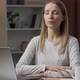 Female freelancer daydreaming at home. Smiling woman sitting at the table with laptop - VideoHive Item for Sale