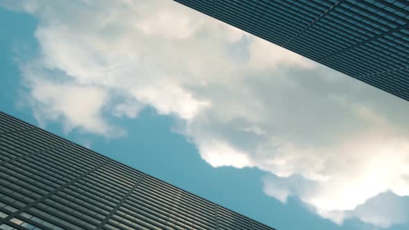 Airplane Flies Over Office Skyscrapers Against a Beautiful Blue Clouds