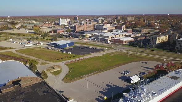 Aerial of WWII museum ship and surrounding urban area in Muskegon, MI