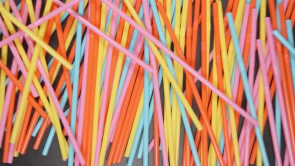 Many colour tubes fall on a black table