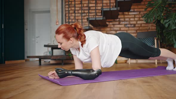Woman with Robotic Hand Doing Physical Exercises