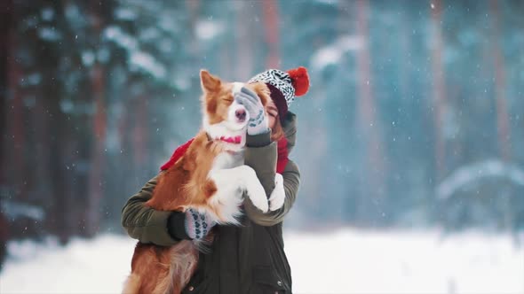 Smiling Lady Take Free Time Together with Her Dog. Portrait of Woman Hug Her Border Collie in Winter