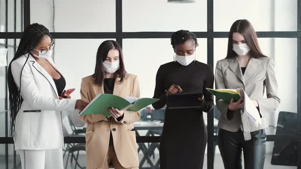 Multiethnic Business Colleagues Reviewing Paper Documents