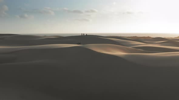  Slow Motion Aerial View of People Walking By the Sand Dunes, California Nature