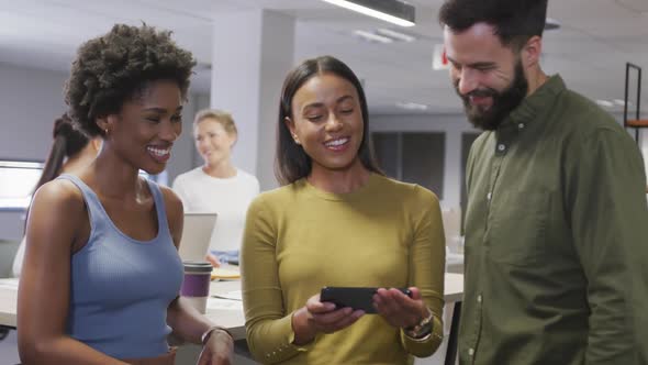 Portrait of happy diverse male and female business colleagues discussing