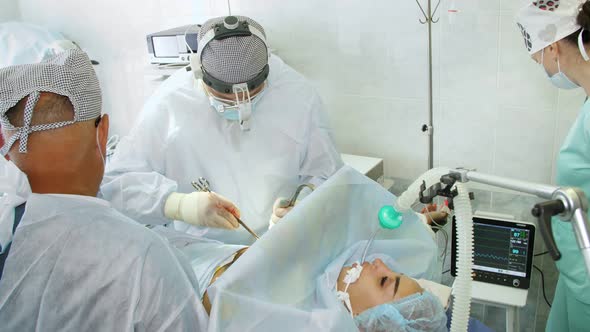 Surgeon and His Assistant Clean Site for Breast Implant, Performing Cosmetic Surgery in Hospital