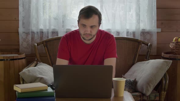 Young Handsome Man in Casual Wear Working at Laptop From Home, Surfing Net