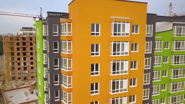 Aerial view of city residential area with high apartment buildings under construction.