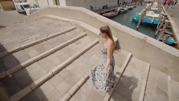 Woman Walks on Bridge Across Chioggia Canal