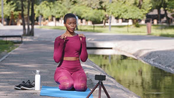 Excited Millennial Beautiful Yoga Instructor Recording Vlog on Cellphone Basic Exercise Fitness
