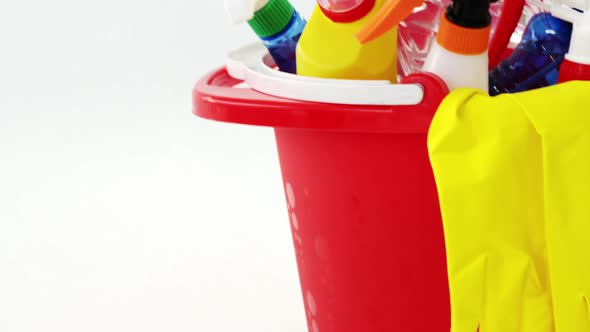 Various housekeeping supplies in a bucket