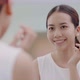 Fresh healthy skin of Asian girl looking at mirror and patting face with finger. - VideoHive Item for Sale