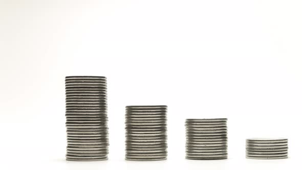 Silver Coins on Stacks Are Decrease and Increase on White Background Stop Motion Animation alt
