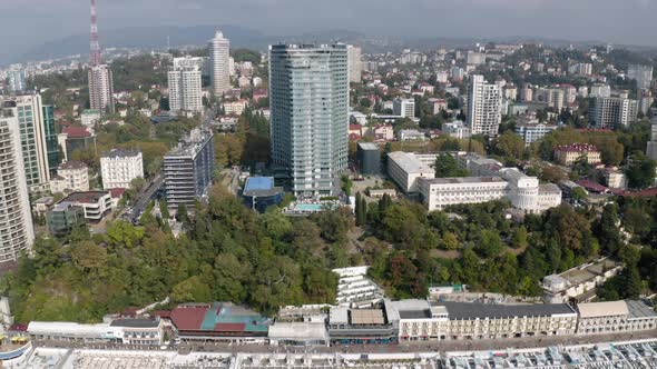 Aerial Reverse View City Sochi Modern Architecture with Waterfront at Sunny Autumn Day