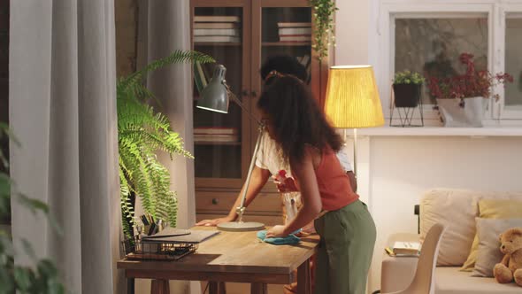 Afro Mom And Daughter Cleaning Table Together