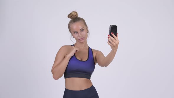 Young Beautiful Blonde Woman Taking Selfie with Phone