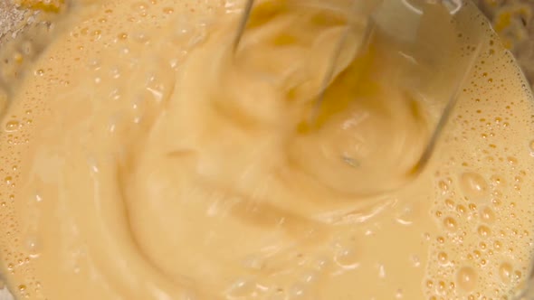 Whipping Liquid Dough with Electric Mixer in Slow Motion, Closeup