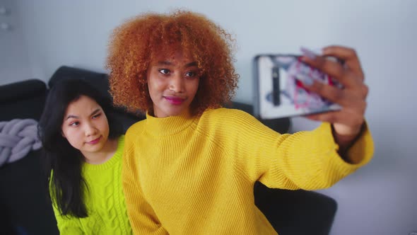 Multiracial Friendship. Asian and African American Black Woman Taking Selfie Using Smartphone