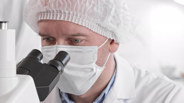 Medical Scientist Using Microscope