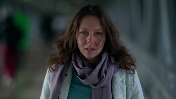 Portrait of an Emotional Middle-aged Brown-haired Woman Who Is Walking in a Crowded Pedestrian