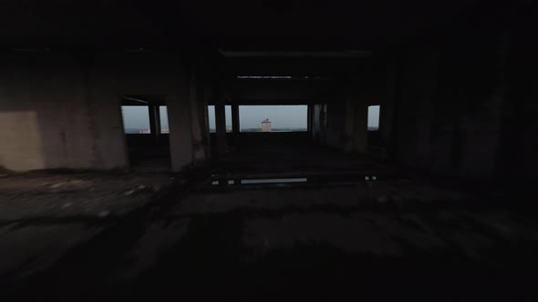 FPV Drone Quickly Flies Through an Abandoned Building and Moves Away From It