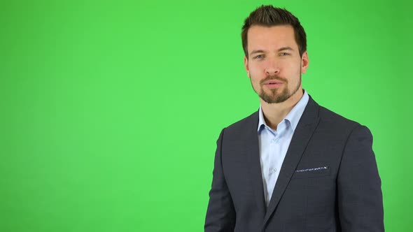 A Young Handsome Businessman Talks To the Camera and Presses an Invisible Button in Front of Him