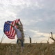 Happy Patriotic Young Woman Spins with the US Flag and Jumps Into the Field - VideoHive Item for Sale