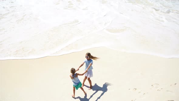 Adorable Little Kids Play Together on the Beach at Shallow water.View From Above of Deserted Beach