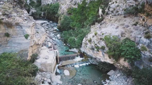 Aerial drone view of Kourtaliotis gorge waterfall Crete
