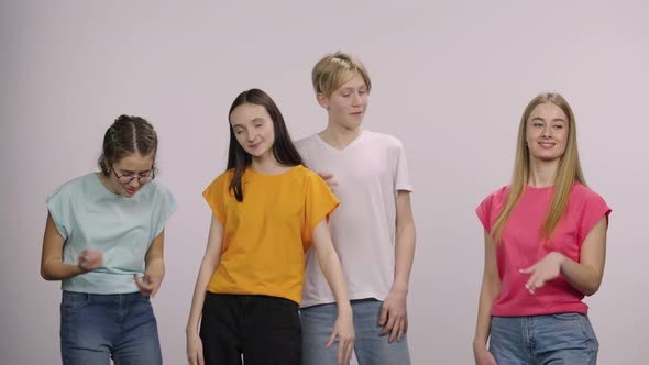 A Group of Cute Young People Looking at the Camera and Having Fun Dancing and Having Fun