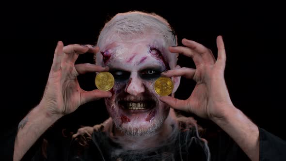 Zombie Man with Makeup with Fake Wounds Scars Showing Golden Bitcoins Mining Btc Cryptocurrency