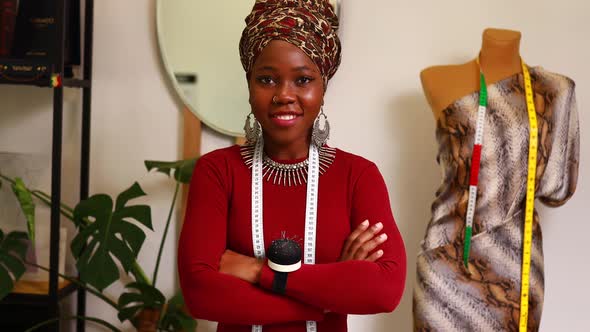 Afro American Woman with Turban Over Head and Silver Ethnic Colorful Jewelry in Tailor Workshop