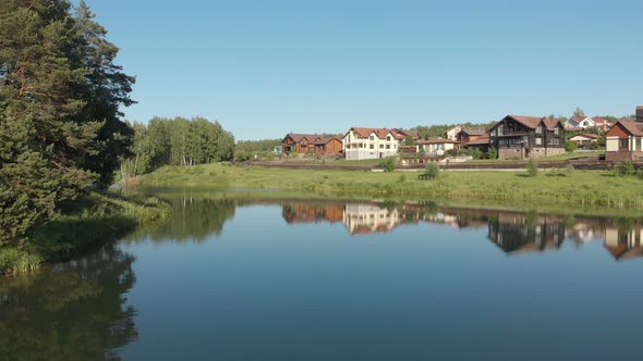 View of the country village. Flying drone above the pond