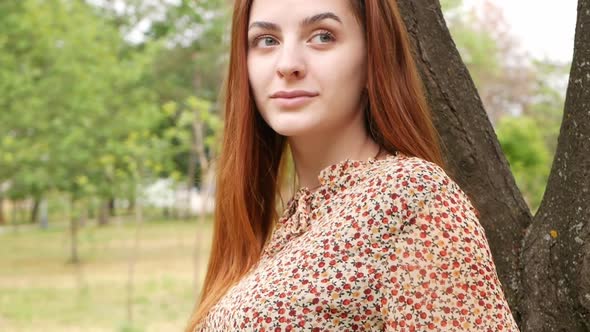 A Portrait Young Woman in a Summer Dress with a Bike for Hire